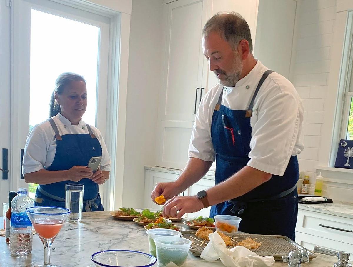 A private chef plating dishes in a rental kitchen